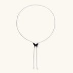 Wooden butterfly pendant necklace with cascading silver-toned chains on adjustable chain, available in amber and black.