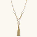 Long gold-plated necklace with freshwater pearls, chunky chain links, and flowing tassel pendant